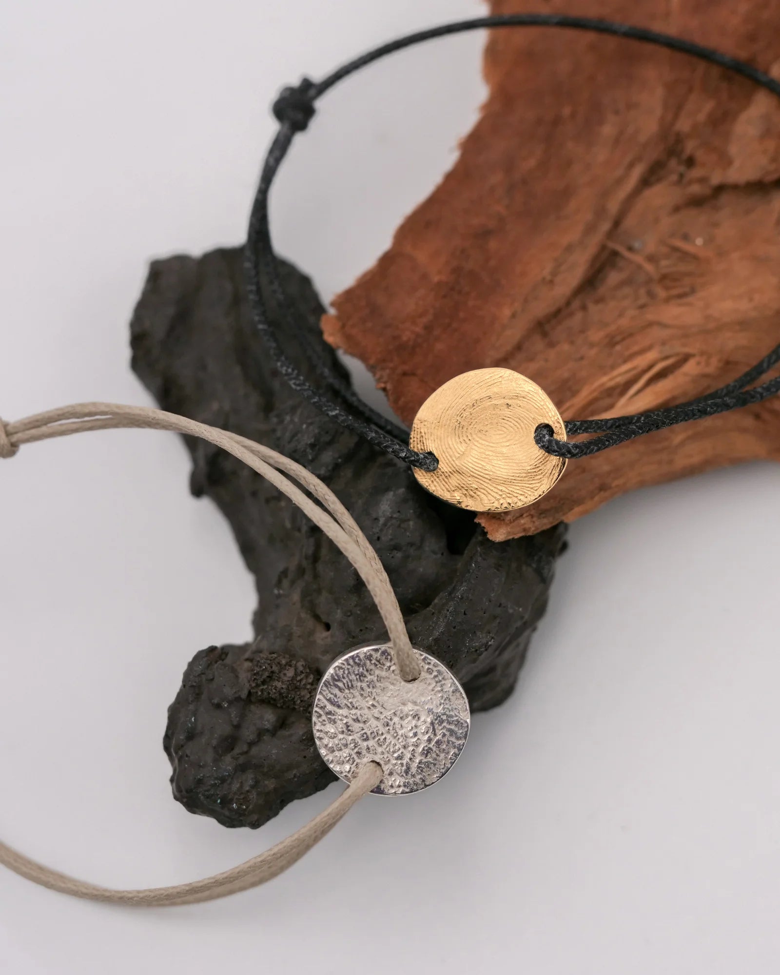 Duo de bracelets argent et vermeil avec empreintes animales et digitales.