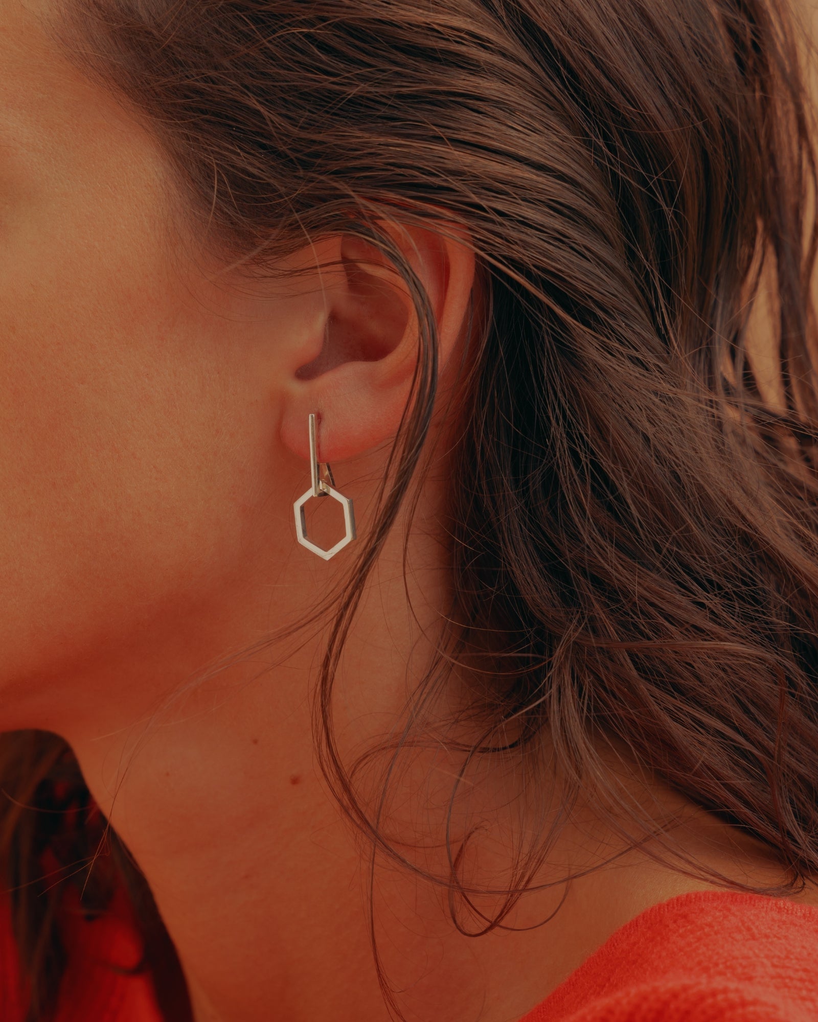 Photo portée d'un pendentif éthique et modulable modèle Essentiel 14mm en argent ajouter sur une boucle d'oreille éthique modèle Mouvement en argent.